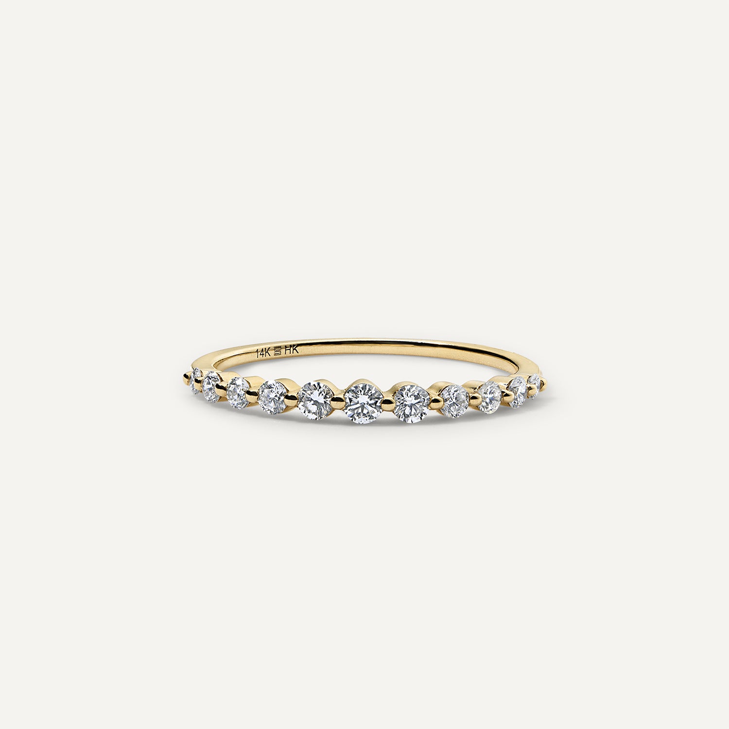 11 round lab grown diamonds graduate along half of the band.